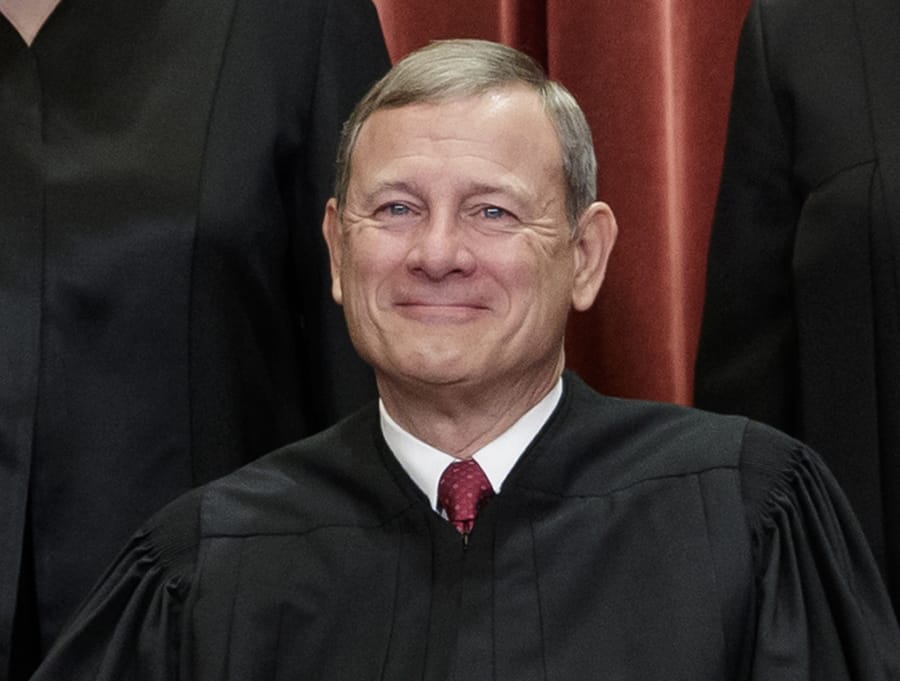 FILE - This Nov. 30, 2018, file photo shows Chief Justice of the United States, John G. Roberts, as he sits with fellow Supreme Court justices for a group portrait at the Supreme Court Building in Washington. Federal judges are taking up the challenge to educate Americans about how their government works at a time when false information can spread instantaneously on social media, Chief Justice John Roberts wrote Tuesday in his annual year-end report. (AP Photo/J.