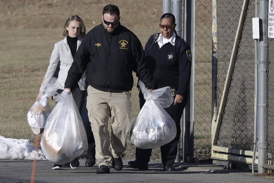 Michelle Carter, left, leaves the Bristol County jail, Thursday, Jan. 23, 2020, in Dartmouth, Mass., after serving most of a 15-month manslaughter sentence for urging her suicidal boyfriend to kill himself in 2014. The 23-year-old, released three months early for good behavior, will serve five years of probation.