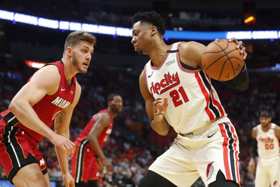 Portland Trail Blazers center Hassan Whiteside (21) drives up against Miami Heat forward Meyers Leonard (0) during the first half of an NBA basketball game, Sunday, Jan. 5, 2020, in Miami.
