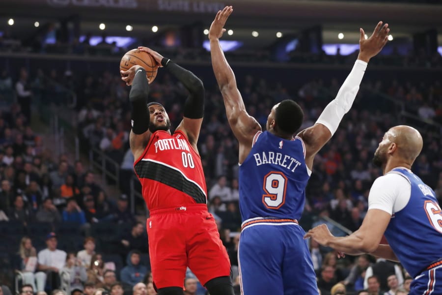 New York Knicks guard RJ Barrett (9) defends as Portland Trail Blazers forward Carmelo Anthony (00) shoots during the first half of an NBA basketball game in New York, Wednesday, Jan. 1, 2020.