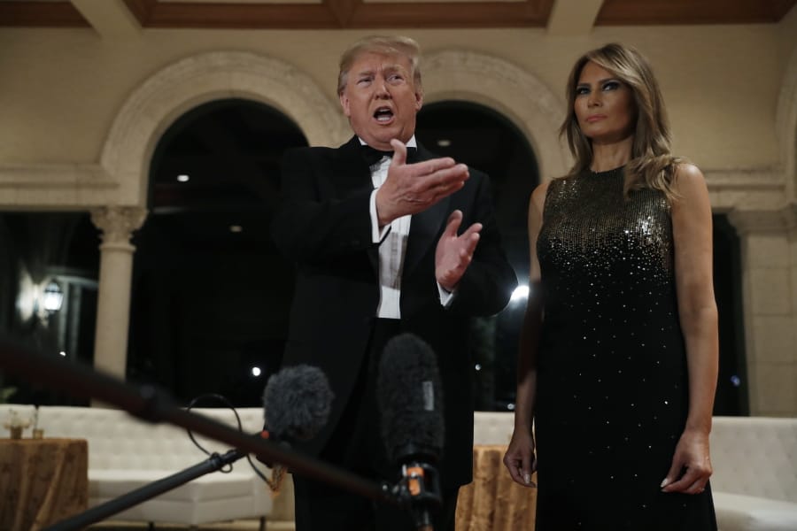 President Donald Trump speaks to the media about the situation at the U.S. embassy in Baghdad, from his Mar-a-Lago property, Tuesday, Dec. 31, 2019, in Palm Beach, Fla., as Melania Trump stands next to him.