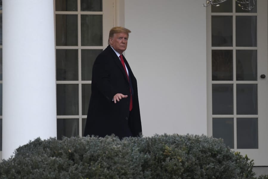 President Donald Trump walks along the colonnade of the White House in Washington, Monday, Jan. 13, 2020. Trump is heading to New Orleans, to attend the College Football Playoff National Championship between Louisiana State University and Clemson.