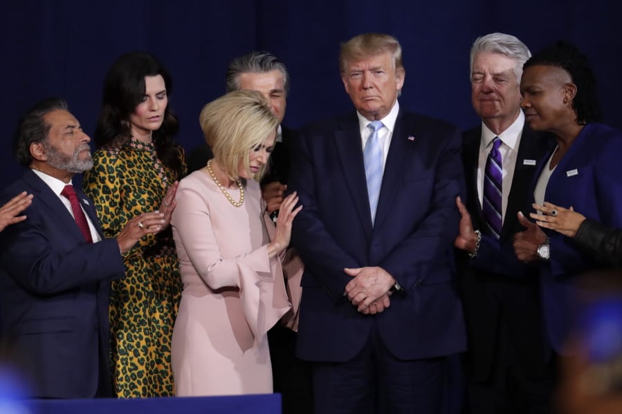 FILE - In this Jan. 3, 2020, file photo, faith leaders pray with President Donald Trump during a rally for evangelical supporters at the King Jesus International Ministry church in Miami. As he heads into the 2020 election, Donald Trump will become the first sitting president to address the March for Life when he takes the stage Friday at the annual anti-abortion gathering. The move is Trump&#039;s latest nod to the white Evangelical, conservative Christian voters who have proven to be among his most loyal backers.