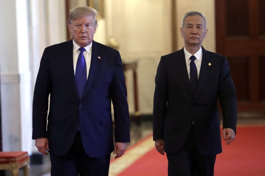 President Donald Trump walks with Chinese Vice Premier Liu He, left, to the East Room of the White House, Wednesday, Jan. 15, 2019, in Washington, to sign a trade agreeement.