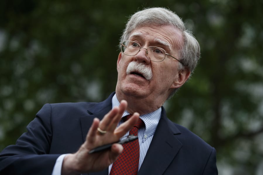 FILE - In this May 1, 2019 file photo, National security adviser John Bolton talks to reporters outside the White House in Washington.