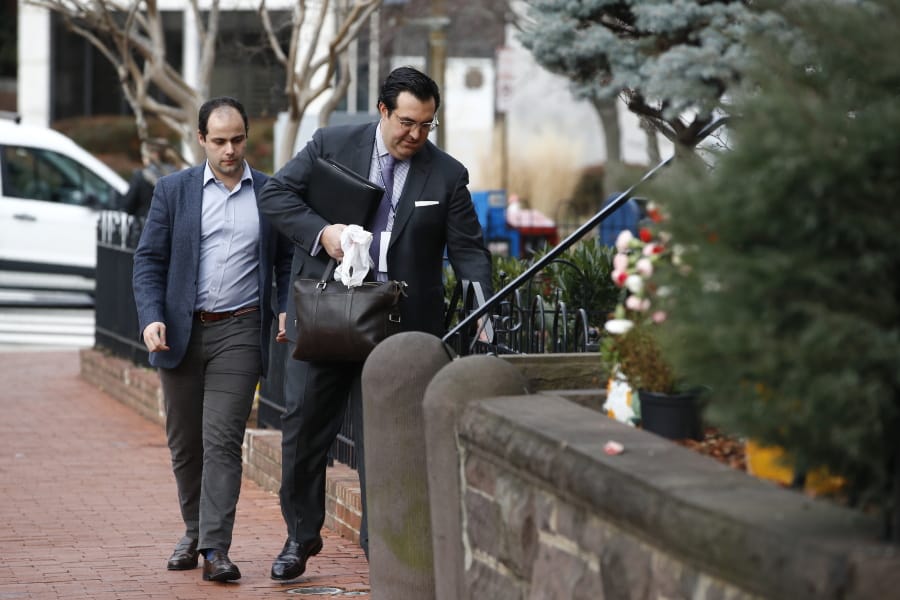 In this Jan. 28, 2020 photo, Jordan Sekulow, right, the executive director of American Center for Law and Justice, opens a gate as he arrives at a property on Capitol Hill in Washington.
