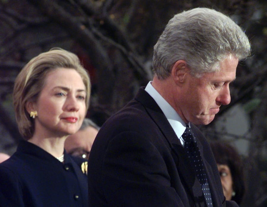 FILE - In this Dec. 19, 1998 file photo, first lady Hillary Rodham Clinton watches President Clinton pause as he thanks those Democratic members of the House of Representatives who voted against impeachment at the White House in Washington.