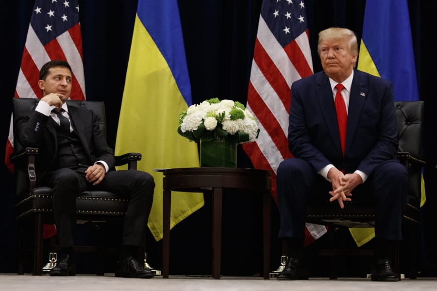 FILE - In this Sept. 25, 2019, file photo, President Donald Trump meets with Ukrainian President Volodymyr Zelenskiy at the InterContinental Barclay New York hotel during the United Nations General Assembly, in New York. It&#039;s the story of a president who either had a &quot;perfect phone call&quot; with Ukraine or abused his power and should be removed from office. What to watch as presidential impeachment arguments get underway in the Senate for only the third time in American history.
