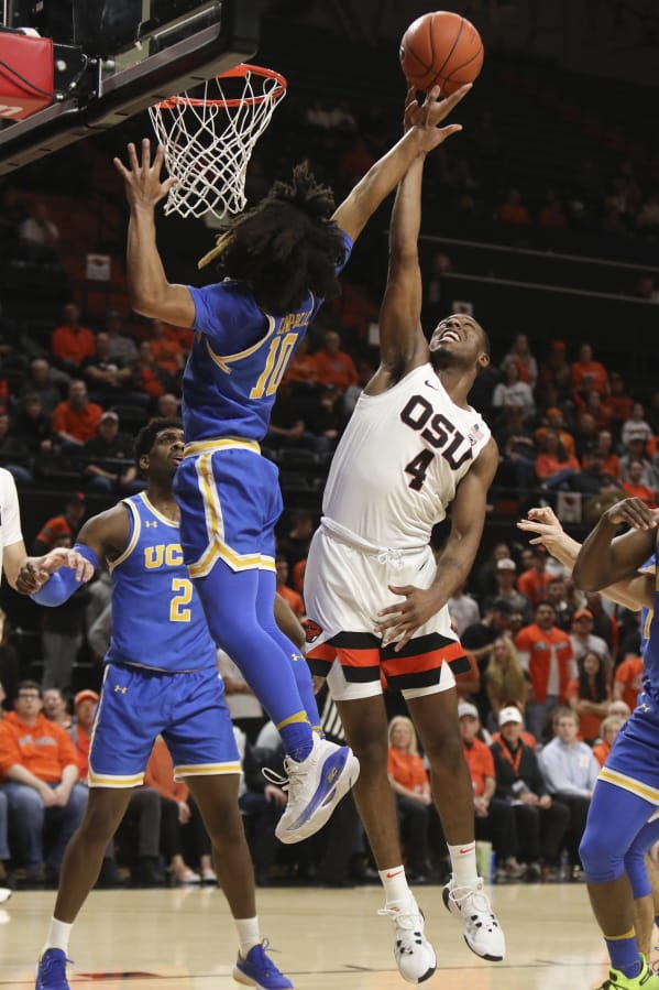 UCLA&#039;s Tyger Campbell (10) blocks a basket by Oregon State&#039;s Alfred Hollins (4) during the first half of an NCAA college basketball game in Corvallis, Ore., Thursday, Jan. 23, 2020.