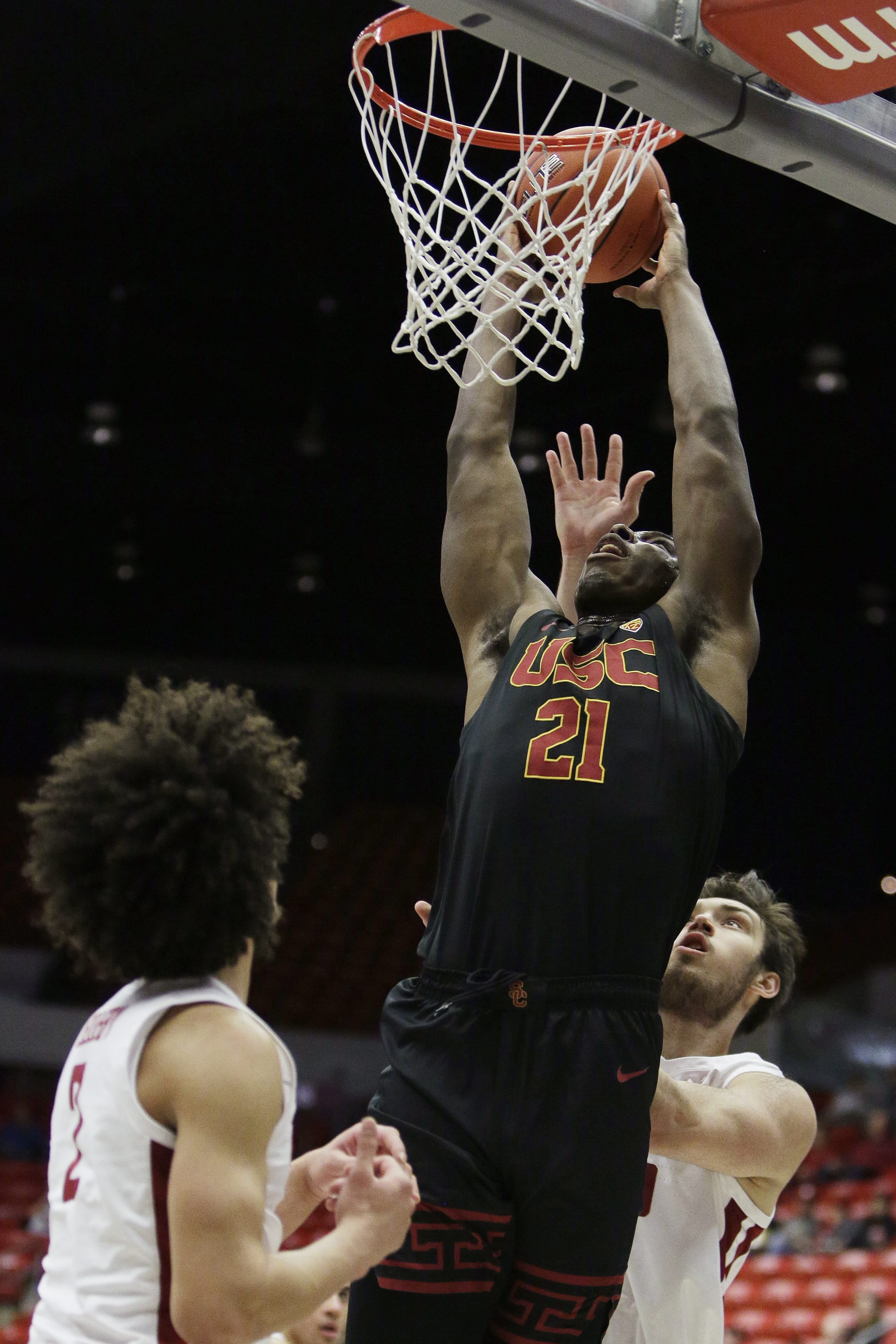 Southern California forward Onyeka Okongwu, center, goes up for a dunk between Washington State forward CJ Elleby, left, and center Volodymyr Markovetskyy during the first half of an NCAA college basketball game in Pullman, Wash., Thursday, Jan. 2, 2020.