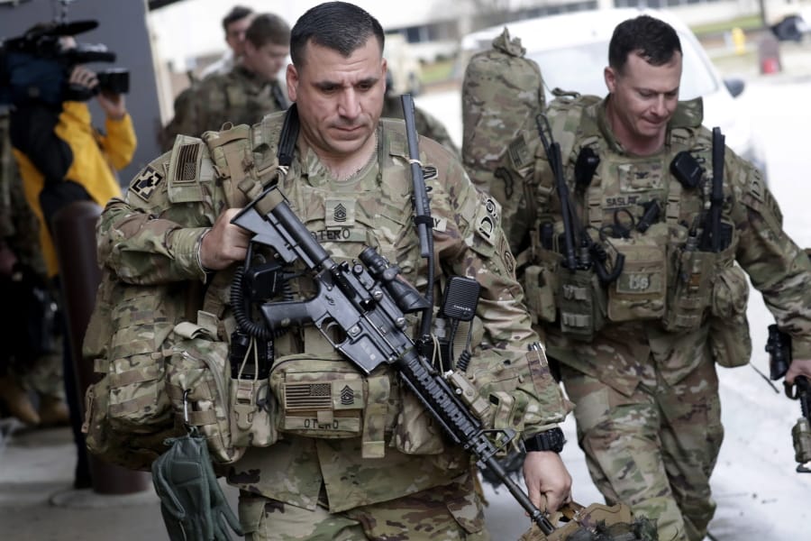 U.S. Army soldiers with their gear head to an awaiting bus Saturday, Jan. 4, 2020 at Fort Bragg, N.C., as troops from the 82nd Airborne are deployed to the Middle East as reinforcements in the volatile aftermath of the killing of Iranian Gen. Qassem Soleimani.