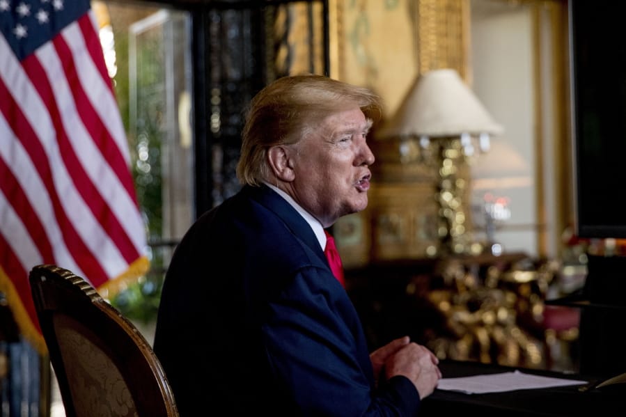 FILE - In this Dec. 24, 2019 photo, President Donald Trump speaks to members of the media following a Christmas Eve video teleconference with members of the military at his Mar-a-Lago estate in Palm Beach, Fla. Trump says Iranian Gen. Qassem Soleimani, the target of a Friday U.S. airstrike in Iraq was &quot;plotting to kill&quot; many Americans.