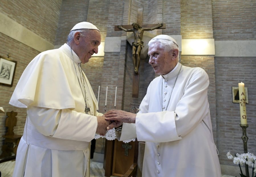 FILE - In this June 28, 2017, file photo, Pope Francis, left, and Pope Benedict XVI, meet each other on the occasion of the elevation of five new cardinals at the Vatican. Retired Pope Benedict XVI has broken his silence to reaffirm the value of priestly celibacy, co-authoring a bombshell book at the precise moment that Pope Francis is weighing whether to allow married men to be ordained to address the Catholic priest shortage.