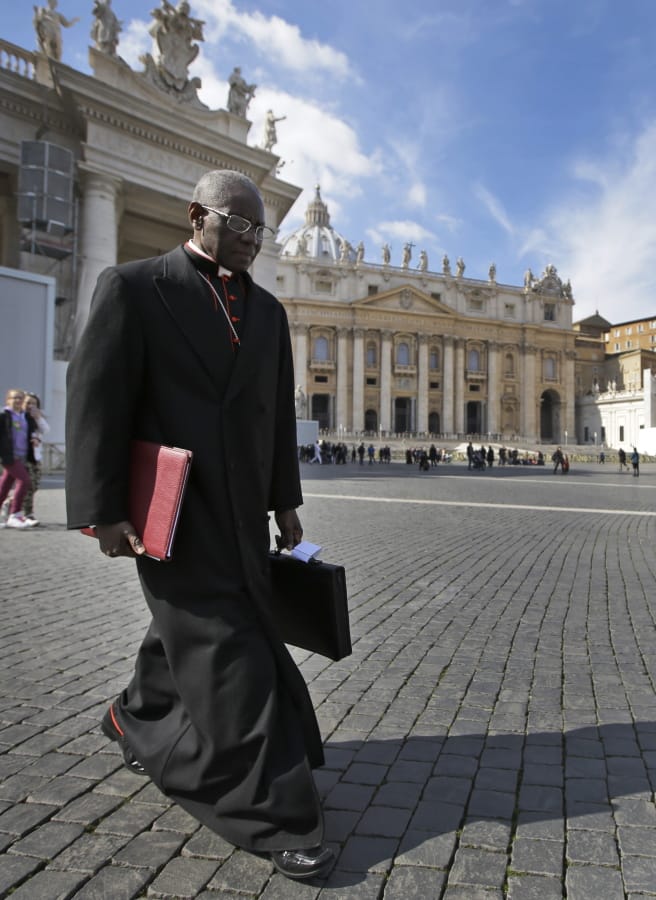 Cardinal Robert Sarah, of Guinea, walks in March 2013 in St. Peter&#039;s Square. Retired Pope Benedict XVI wrote the book, &quot;From the Depths of Our Hearts,&quot; along with Sarah, who heads the Vatican&#039;s liturgy office and has been a quiet critic of Francis.