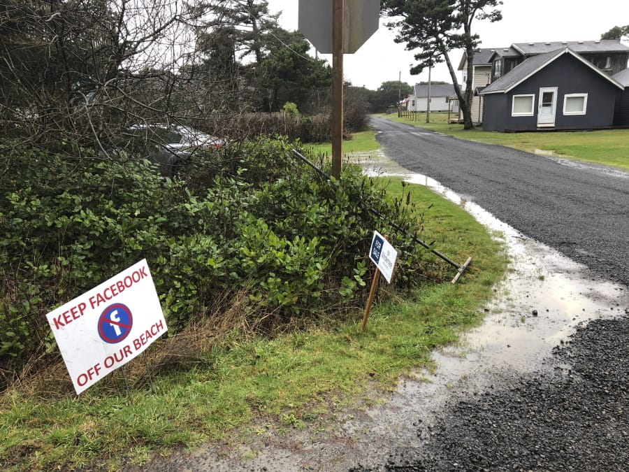A sign expressing opposition to a plan by Facebook to build a landing spot for a submarine cable connecting America with Asia stands on property in the tiny community of Tierra del Mar, Ore., Wednesday, Jan. 8, 2020.