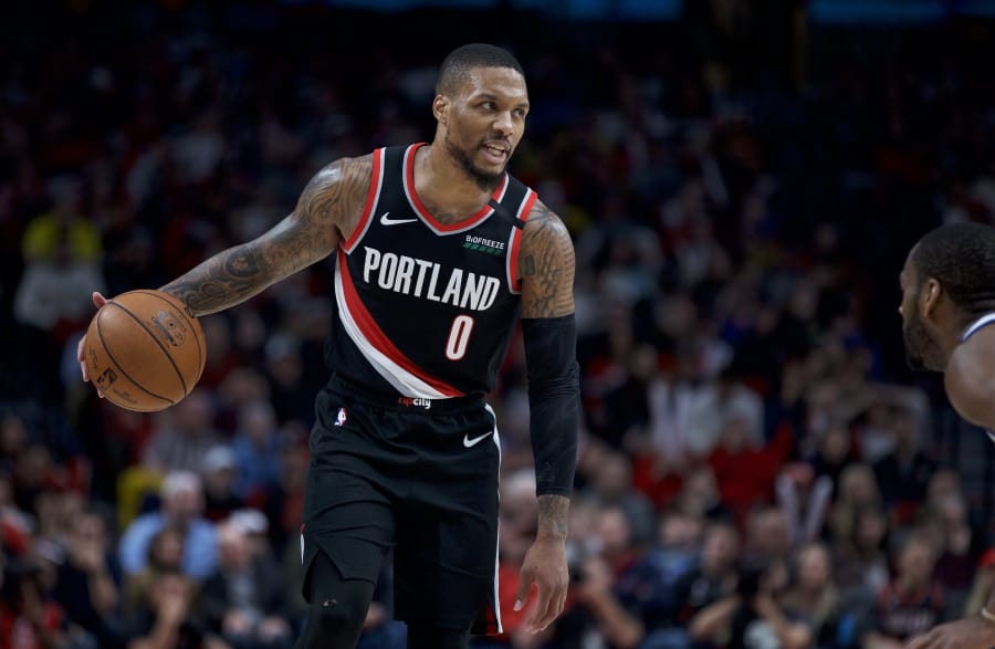 Portland Trail Blazers guard Damian Lillard brings the ball up the court against the Golden State Warriors during the second half of an NBA basketball game in Portland, Ore., Monday, Jan. 20, 2020. The Trail Blazers won 129-124 in overtime.