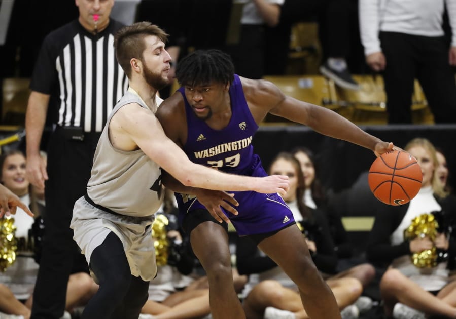 Washington forward Isaiah Stewart, right, drives into Colorado forward Lucas Siewert in the second half of an NCAA college basketball game Saturday, Jan. 25, 2020, in Boulder, Colo.