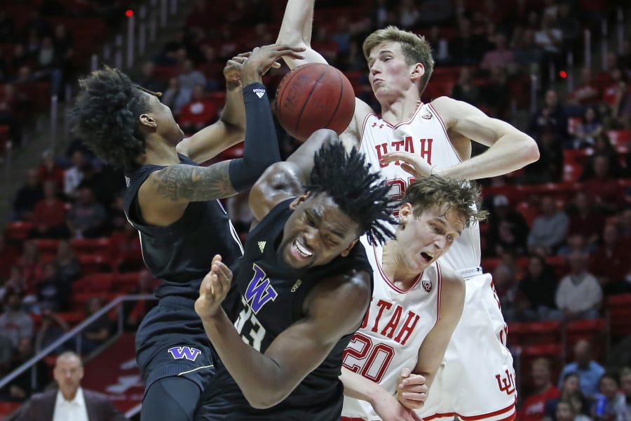Washington&#039;s Jaden McDaniels, left, and Isaiah Stewart (33) battle against Utah&#039;s Mikael Jantunen (20)and Branden Carlson, rear, for a rebound in the first half during an NCAA college basketball game Thursday, Jan. 23, 2020, in Salt Lake City.