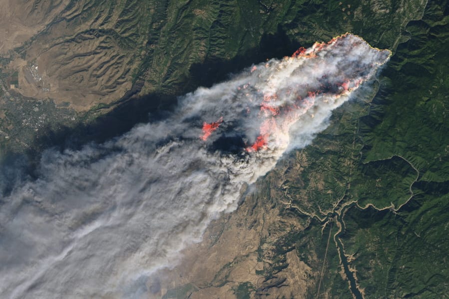This November 2018 image provided by NASA shows flames and smoke from the Camp Fire that erupted 90 miles (140 kilometers) north of Sacramento, Calif. Increasingly intense wildfires that have scorched forests from California to Australia are stoking worry about long-term health impacts from smoke exposure in affected cities and towns.