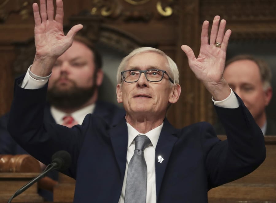 Wisconsin Gov. Tony Evers waves to his family as he gets ready to deliver his State of the State address in the Assembly Chambers at the Wisconsin state Capitol in Madison, Wis., Wednesday, Jan. 22, 2020.