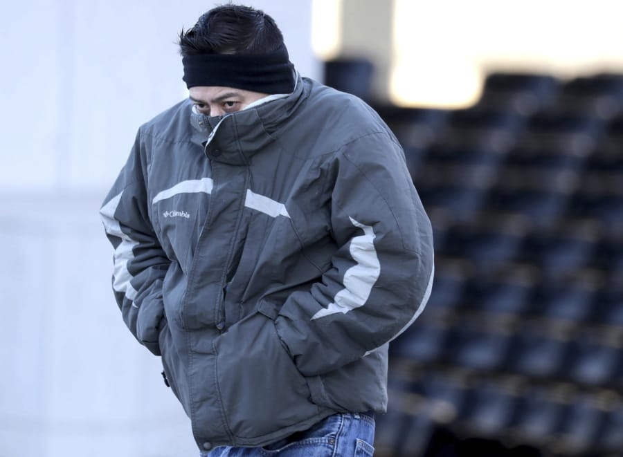 Jorge Hernandez, of Milwaukee, tries to cover his face from the cold while walking along West Kilbourn Avenue in Milwaukee, Thursday, Jan. 16, 2020. While snow is expected Friday, breezy and cold conditions return on Sunday and Monday, with wind chills of minus 10 to minus 15 Fahrenheit across the region, according to the National Weather Service office in Sullivan.