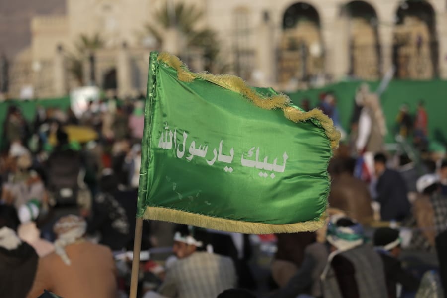 FILE - In this Nov. 9, 2019 file photo, a supporter of Shiite rebels, known as Houthis, holds a banner with Arabic writing that reads, &quot;at your order, oh messenger of Allah,&quot; during a celebration of Mawlid al-Nabi the birth of Islam&#039;s prophet Muhammad in Sanaa, Yemen. A drastic escalation in fighting between the Saudi-led military coalition and Houthi rebels in Yemen has killed and wounded hundreds of people over the past week, officials and tribal leaders said on Monday, Jan. 27, 2020.