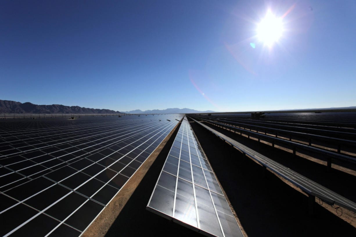 The morning sun rises over the solar panels at the 550-megawatt Desert Sunlight solar farm in Desert Center, Calif.