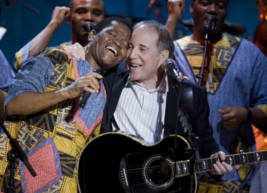 Paul Simon, center, Joseph Shabalala, left, and other members of Ladysmith Black Mambazo perform during the Library Of Congress Gershwin Prize For Popular Song Gala at the Warner Theater May 23, 2007, in Washington, D.C. Shabalala has died at age 78.