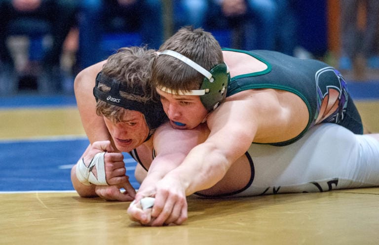 Hudson's Bay's Camden Courtney, bottom, tries to fight for his hand back against Edmonds-Woodway's Alec Rust in their 160-pound championship match at the WIAA Region 2 Tournament on Saturday at Kelso.