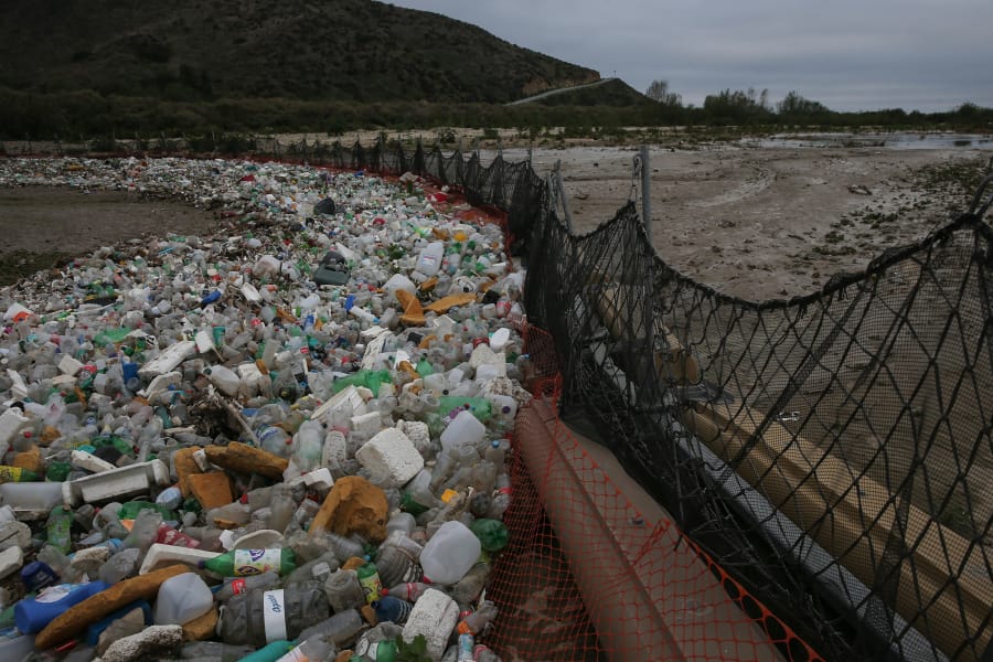 Debris gathers in a catch basin on the U.S. side of the border on March 12, 2018 in San Ysidro, Calif. When it rains, trash and raw sewage flow through the Tijuana River Valley to the ocean.