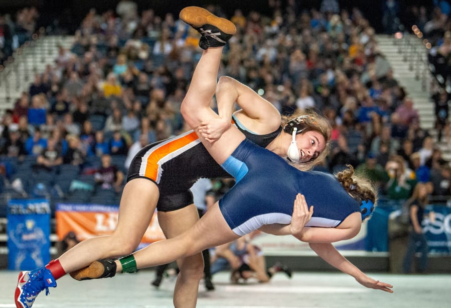 Washougal&#039;s Aleksi Donahue takes down Mount Rainier&#039;s Trisity Marshall in a 120-pound first-round match at Mat Classic XXXII Friday at the Tacoma Dome. Donahue secured the pin quickly afterward.