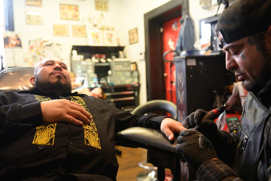 After losing part of two fingers in a work accident 16 years ago, Jose Alvarado receives two fingernail tattoos at Eternal Ink Tattoo Studio on Nov. 20, 2019, in Hecker, Ill. (Michael B.