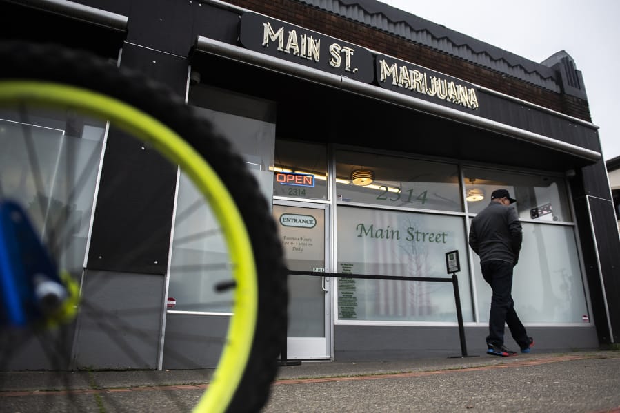 A pedestrian walks past Main Street Marijuana in Vancouver. Co-owner Adam Hamide said his biggest concerns during the current legislative session are bills about THC content and industry labor standards.