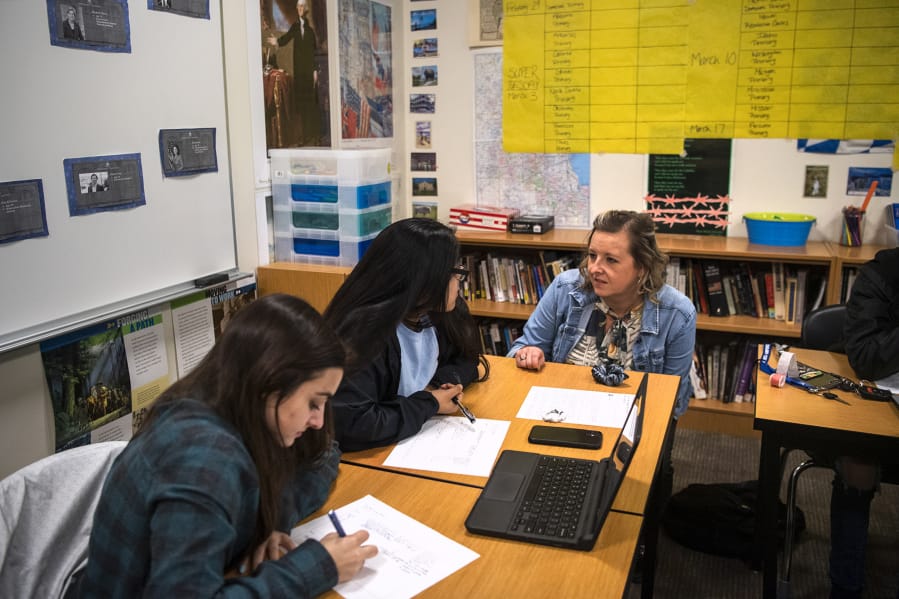 Woodland High School seniors Rachel Young, left, and Ariana Vega, center, talk with their teacher Shari Conditt during their advanced government class at Woodland High School. Experts say allowing students to discuss controversial subjects in the classroom can build more critical readers, thinkers and voters.