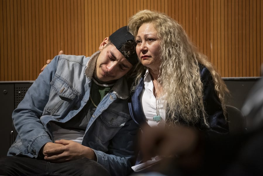 Lennes Flores, left, cries while hugging his mother, Enedis Flores, after watching a documentary that tells their family&#039;s story during The Columbian&#039;s &quot;Bridging the Border&quot; forum at the Vancouver Community Library on Thursday.