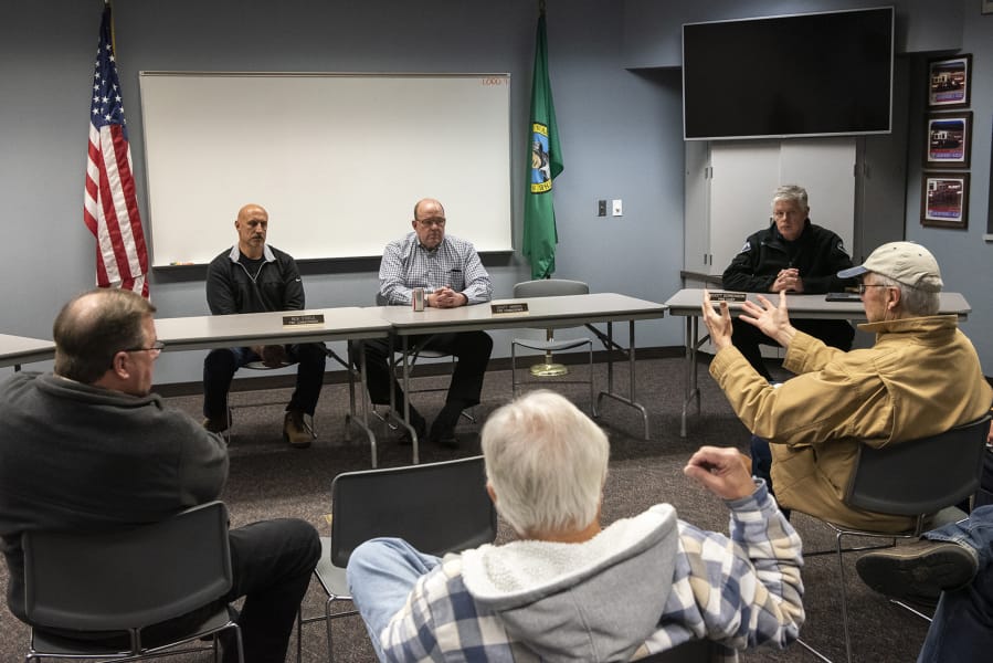Clark County Fire District 3 Commissioners Rick Steele, center left, and Scott Anders, center right, listen to residents during an informational meeting about annexation Tuesday night at Station 31 in Brush Prairie.