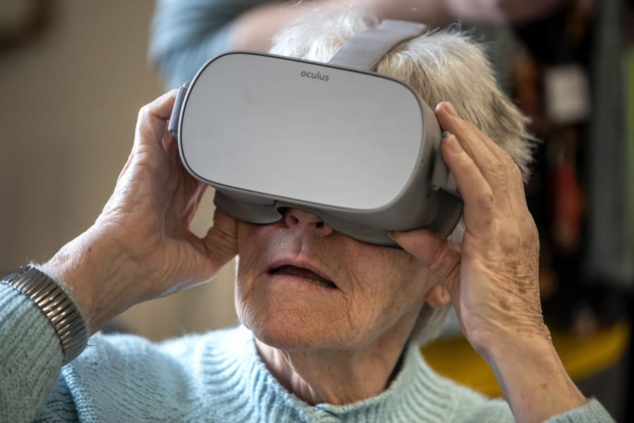 Bonaventure of Vancouver resident Patricia Hulslander tries out a photographic tour of Paris&#039;s Notre-Dame Cathedral with a virtual reality headset at the retirement community in Vancouver. Fort Vancouver Regional Libraries worked with Bonaventure of Vancouver to provide residents with the virtual vacation activity.