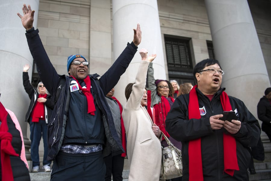 Amon Rutherford of Vancouver, left, and Gary Akizuki, right, cheer as the 17th Legislative District is called during a rally at Housing and Homelessness Advocacy Day on the Capitol steps in Olympia. Akizuki has been coming to the advocacy day since 2003 when a smaller crowd met with legislators. &quot;The things we do up here, lobbying, makes a difference,&quot; he said.