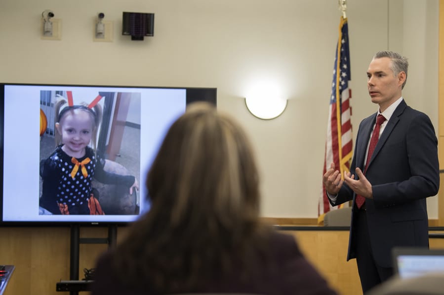 The image of victim Hartley Anderson, 5, left, is displayed for the jury as Senior Deputy Prosecutor James Smith gives his opening statement Tuesday in the murder trial of Ryan M. Burge in Clark County Superior Court. He stands accused of killing his then-girlfriend&#039;s daughter.