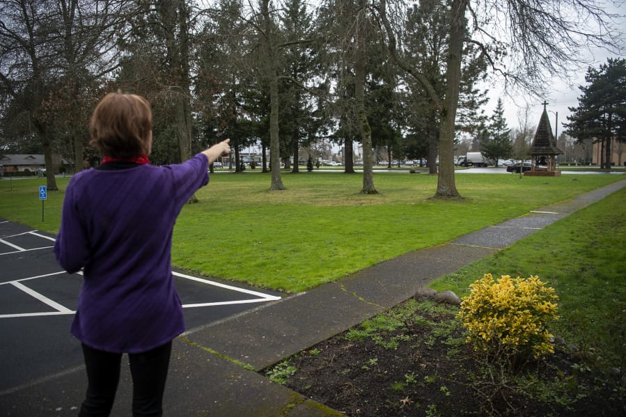 The Rev. JoAnn Schaadt-Shipley of Vancouver Heights United Methodist Church points to the area on the grounds where the church is hoping to build a walking labyrinth.