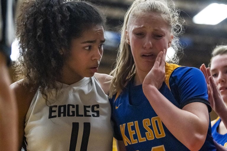 Hudson’s Bay’s Jaydia Martin, left, checks on Kelso’s Natalie Fraley after Fraley was hit in the face on a drive during a game at Mountain View High School on Friday night, Feb. 7, 2020.