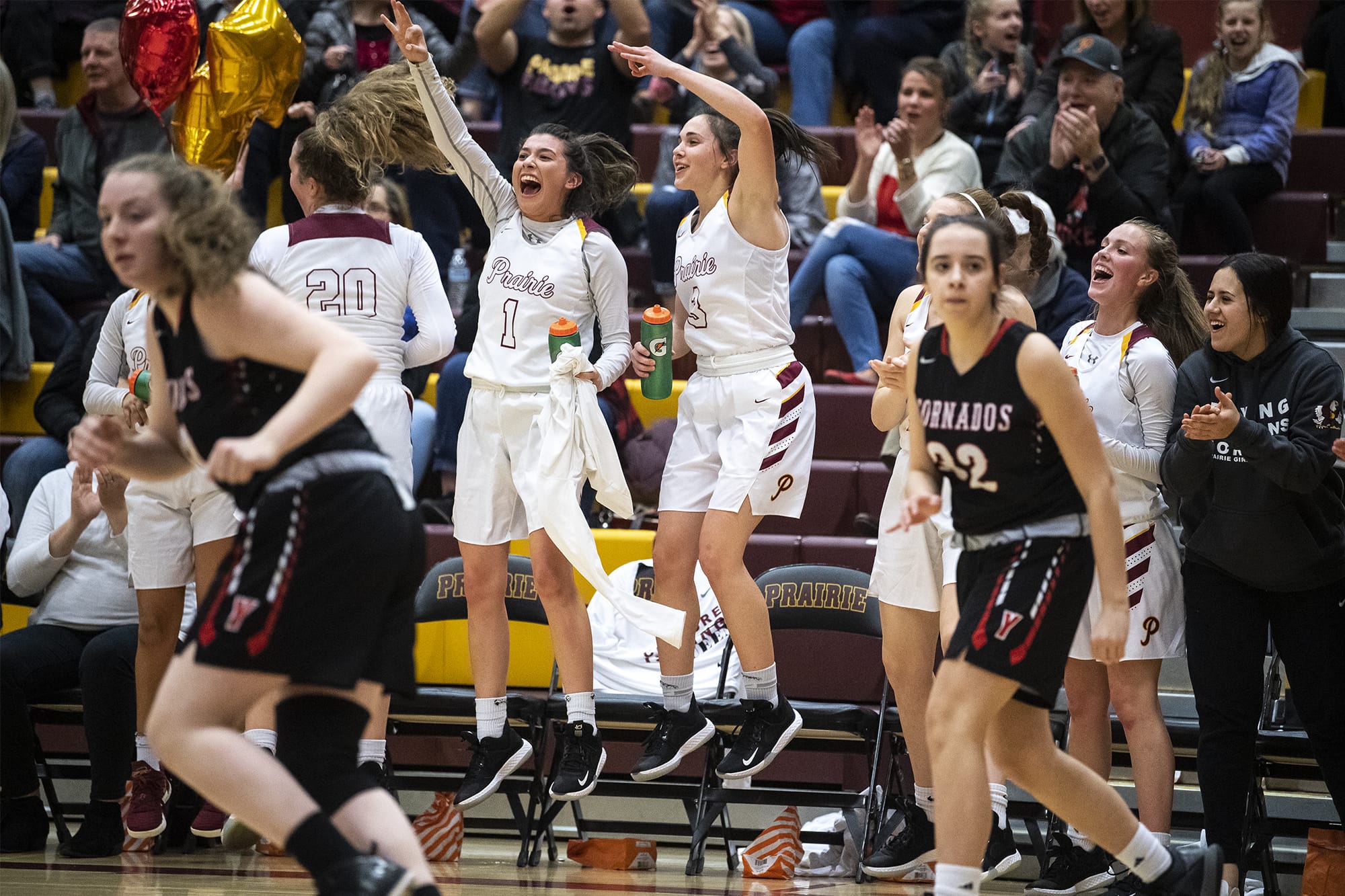 The Prairie bench reacts to a three during a game against Yelm at Prairie High School on Friday night, Feb. 14, 2020.