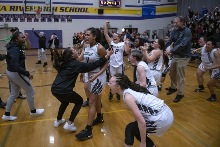 Hudson’s Bay players join their fans to celebrate their victory over Prairie High School in the 3A district semifinals at Columbia River High School on Feb. 19, 2020. The Hudson’s Bay Eagles defeated the Prairie Falcons 46-45.