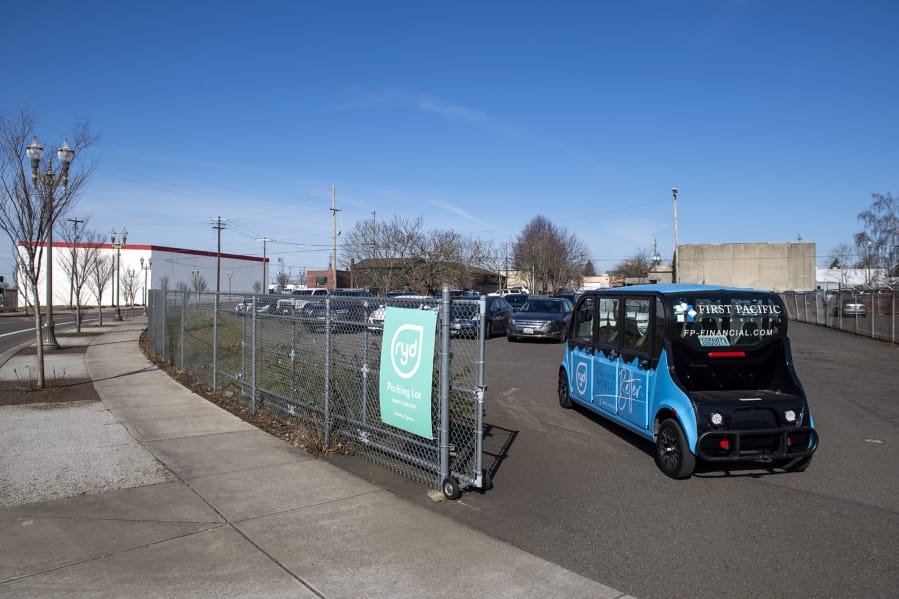 One of the five RYD cars travels into a shared parking lot off Jefferson Street in Vancouver. RYD partners with multiple businesses throughout downtown Vancouver to provide rides for their employees to and from designated parking lots.