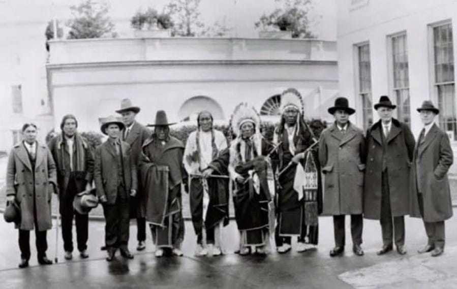 Frank Iyall, third from right, stands with President Calvin Coolidge, far right, in the 1920s. Iyall lobbied the federal government for Native American rights and recognition, a fight his descendants continued.