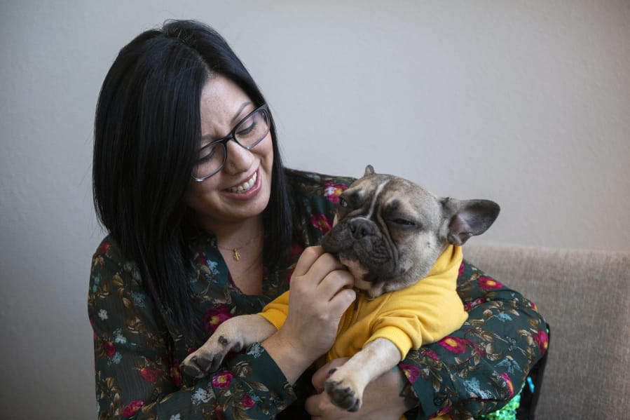 Erica London is a third-generation Latina born in the United States. Her therapy business is one of a handful of businesses in Clark County owned by a woman and a minority. Her French bulldog, Courage, accompanies her to work. &quot;Clients love him,&quot; she said.