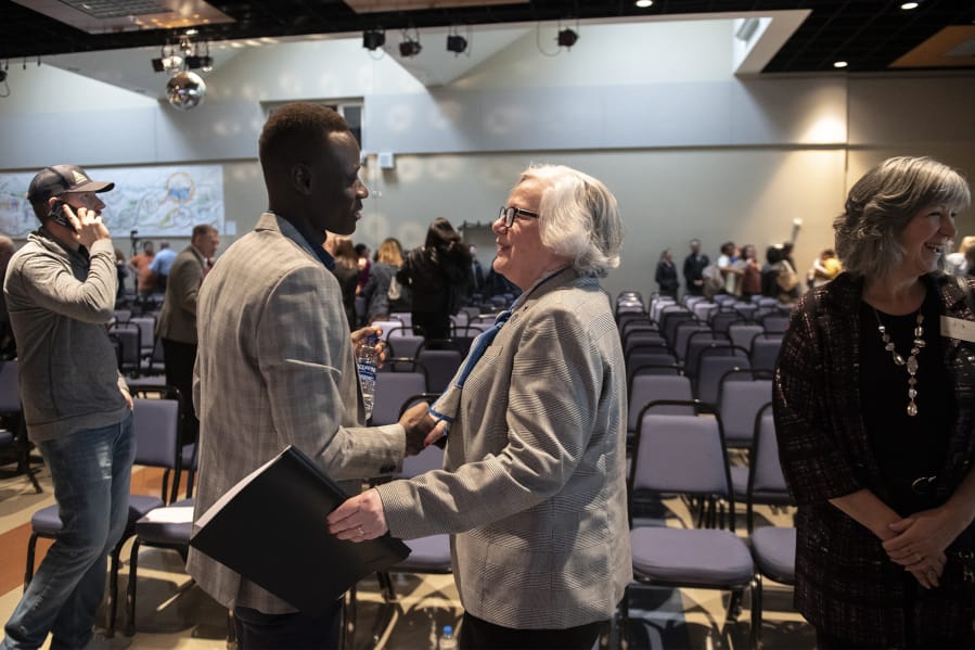 Evan Kamme, left, president of the Associated Students of Clark College, greets Sandra Fowler-Hill, interim president of Clark College, following the 2020 State of the College address at Clark College on Wednesday. Fowler-Hill&#039;s speech reflected on the challenges of the last year while looking forward with optimism at the future of the college.