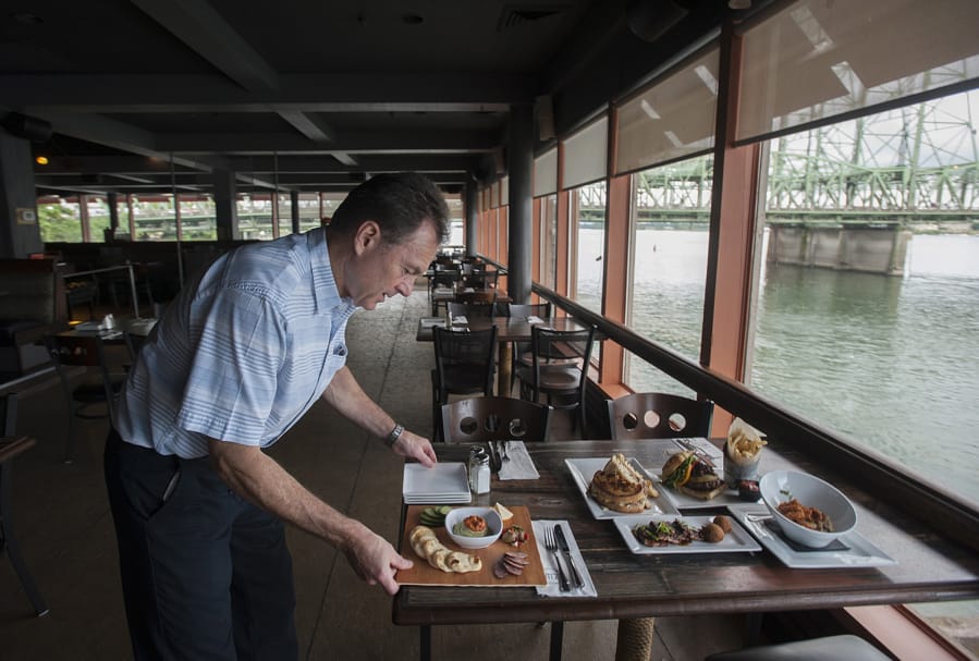 Owner Mark Matthias serves up food at WareHouse &#039;23. The restaurant is scheduled to close at the end of this year after four-and-a-half years in operation.