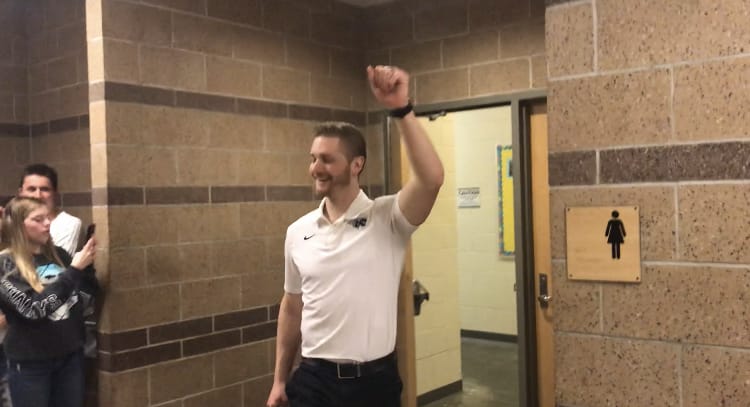 Battle Ground coach Manny Melo celebrates outside the Tigers’ lockerroom after their overtime win Wednesday over Kentwood.