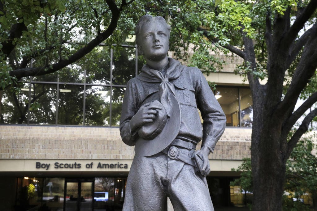 In this Wednesday, Feb. 12, 2020, photo, a statue stands outside the Boys Scouts of America headquarters in Irving, Texas. The Boy Scouts of America has filed for bankruptcy protection as it faces a barrage of new sex-abuse lawsuits. The filing Tuesday, Feb. 18, in Wilmington, Delaware, is an attempt to work out a potentially mammoth compensation plan for abuse victims that will allow the 110-year-old organization to carry on.